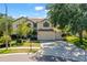 Traditional two-story home with a manicured lawn, mature trees, and a three car garage at 5160 Loquat Ct, Palm Harbor, FL 34685