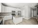 Bright, open kitchen with white cabinetry, stainless steel appliances, granite countertops, and a central island at 5160 Loquat Ct, Palm Harbor, FL 34685