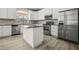 Modern kitchen with stainless steel appliances, granite countertops, and island at 5160 Loquat Ct, Palm Harbor, FL 34685