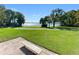Tranquil lake view from a community park with a bench and grassy area for relaxing and enjoying nature at 5160 Loquat Ct, Palm Harbor, FL 34685