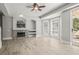 Inviting living room with fireplace, built-ins, and large windows for natural light at 5160 Loquat Ct, Palm Harbor, FL 34685