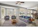 Bright living room with neutral furniture, shutters, and water view at 5160 Loquat Ct, Palm Harbor, FL 34685