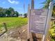 Lansbrook Lakefront Park sign detailing park rules and regulations, near a grassy area and waterfront at 5160 Loquat Ct, Palm Harbor, FL 34685