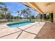 Inviting screened-in pool area with beautiful lake views at 5160 Loquat Ct, Palm Harbor, FL 34685