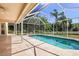Inviting screened-in pool area with beautiful lake views at 5160 Loquat Ct, Palm Harbor, FL 34685