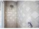 A beautifully tiled shower features diamond tile accents and a chrome shower head fixture at 5160 Loquat Ct, Palm Harbor, FL 34685