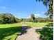 Picturesque walking path winds through lush greenery, perfect for a peaceful stroll at 5160 Loquat Ct, Palm Harbor, FL 34685