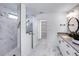 A modern bathroom features a glass-enclosed shower, sleek vanity, and stylish fixtures with marble style tile flooring at 5634 Clearwater Ct, Lakewood Ranch, FL 34211