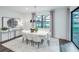 Bright dining area features a modern chandelier, white table and chairs, and a view of the pool at 5634 Clearwater Ct, Lakewood Ranch, FL 34211