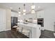 Modern kitchen with white cabinets, a center island, stainless steel appliances, and stylish pendant lighting at 5634 Clearwater Ct, Lakewood Ranch, FL 34211