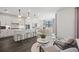 Bright kitchen with white cabinets, island seating, stainless steel appliances, and an open living space at 5634 Clearwater Ct, Lakewood Ranch, FL 34211