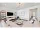 Comfortable living room with sectional sofa, media center, and modern decor at 5634 Clearwater Ct, Lakewood Ranch, FL 34211