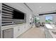 Stylish lounge featuring a modern kitchenette, comfortable seating, and a large-screen television at 5634 Clearwater Ct, Lakewood Ranch, FL 34211