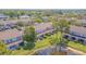 Aerial view of a townhome community featuring lush landscaping and a pond at 6229 Bayside Key Dr, Tampa, FL 33615