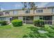 Spacious backyard with lawn, mature landscaping, and a screened patio at 6229 Bayside Key Dr, Tampa, FL 33615