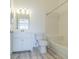Clean bathroom with modern vanity, white tile, and bathtub with shower at 6229 Bayside Key Dr, Tampa, FL 33615