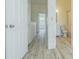 Bright bathroom showcasing updated vanity, toilet, shower-tub combo, and modern wood-look floors at 6229 Bayside Key Dr, Tampa, FL 33615