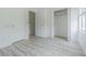 Bedroom featuring wood-look flooring, closet, and natural light from window at 6229 Bayside Key Dr, Tampa, FL 33615
