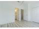 Bedroom featuring wood-look flooring, doors to bathroom and stairs, and closet at 6229 Bayside Key Dr, Tampa, FL 33615