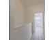 Bright hallway with wood flooring and a view of a room with a large window at 6229 Bayside Key Dr, Tampa, FL 33615