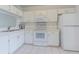 Efficient kitchen with white appliances, ample cabinet space and tile floors at 6229 Bayside Key Dr, Tampa, FL 33615