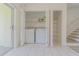 Convenient laundry area with washer, dryer, and extra storage shelving at 6229 Bayside Key Dr, Tampa, FL 33615