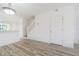 Bright living room featuring wood-look floors, white trim, and a staircase at 6229 Bayside Key Dr, Tampa, FL 33615