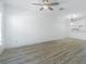 Bright living room boasts wood-look floors, ceiling fan, and neutral color palette at 6229 Bayside Key Dr, Tampa, FL 33615