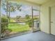 Screened-in patio with scenic view of pond and landscaped grounds at 6229 Bayside Key Dr, Tampa, FL 33615
