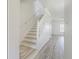 Well-lit staircase with light-colored wood steps and white railing at 6229 Bayside Key Dr, Tampa, FL 33615