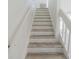 View of staircase with wood-look treads and white risers and railing at 6229 Bayside Key Dr, Tampa, FL 33615