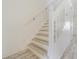 Staircase featuring white railings, light wood treads, and ample natural light at 6229 Bayside Key Dr, Tampa, FL 33615