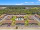 Aerial view of the townhome community showcasing the central pool, landscaping, and ample parking at 7124 Barclay Ave # A, Spring Hill, FL 34609