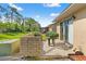 Home backyard featuring grass, patio, and partial privacy wall at 7124 Barclay Ave # A, Spring Hill, FL 34609