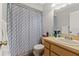 Bathroom featuring a shower with patterned curtain and a single sink vanity at 7124 Barclay Ave # A, Spring Hill, FL 34609