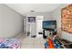 Bedroom featuring neutral walls, tile floors, and a window at 7124 Barclay Ave # A, Spring Hill, FL 34609
