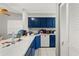 Kitchen with blue cabinetry, sleek countertops, and modern white appliances at 7124 Barclay Ave # A, Spring Hill, FL 34609