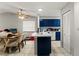 Open kitchen with blue cabinetry, white countertops, and modern appliances, seamlessly connecting to the dining area at 7124 Barclay Ave # A, Spring Hill, FL 34609
