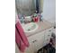 Bathroom vanity with a sink, white cabinets, and pink towel hanging nearby at 7187 53Rd N St, Pinellas Park, FL 33781
