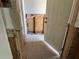Bathroom being renovated with exposed walls, tile flooring and a white door at 7333 Royal Palm Dr # 34652, New Port Richey, FL 34652