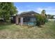 A spacious backyard featuring a screened pool enclosure and well-maintained lawn area at 8332 Berkeley Manor Blvd, Spring Hill, FL 34606