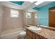Bathroom featuring a shower-tub combo, neutral tile, a white toilet and a light colored countertop with an oval sink at 8332 Berkeley Manor Blvd, Spring Hill, FL 34606