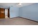 This bright bedroom features blue walls, neutral tile flooring, and a ceiling fan at 8332 Berkeley Manor Blvd, Spring Hill, FL 34606