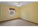 Bright bedroom with tile flooring, a ceiling fan, and natural light at 8332 Berkeley Manor Blvd, Spring Hill, FL 34606