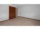 An empty bedroom with wood trim, closet, and tile floors at 8332 Berkeley Manor Blvd, Spring Hill, FL 34606