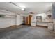 Garage featuring concrete floors, white walls, overhead lights, shelving, and a freezer against the back wall at 8332 Berkeley Manor Blvd, Spring Hill, FL 34606