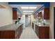 Open kitchen with granite countertops, wood cabinets, and tile flooring at 8332 Berkeley Manor Blvd, Spring Hill, FL 34606