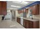 Bright kitchen with granite countertops, wood cabinets, and tile flooring at 8332 Berkeley Manor Blvd, Spring Hill, FL 34606