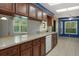 Spacious kitchen with granite countertops, dark wood cabinets, and ample counter space at 8332 Berkeley Manor Blvd, Spring Hill, FL 34606