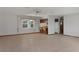 Bright living room with tile floors and a partial view of the kitchen area at 8332 Berkeley Manor Blvd, Spring Hill, FL 34606